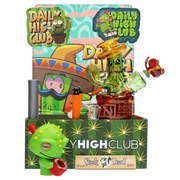 Front three-quarter view of the "Dank Desert" Smoking Box showing a green cactus-shaped glass piece with a brown base and colorful branded backdrop.